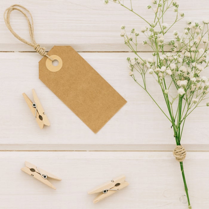 Wedding invitations on kraft paper with illustrations of branches and dried flowers.